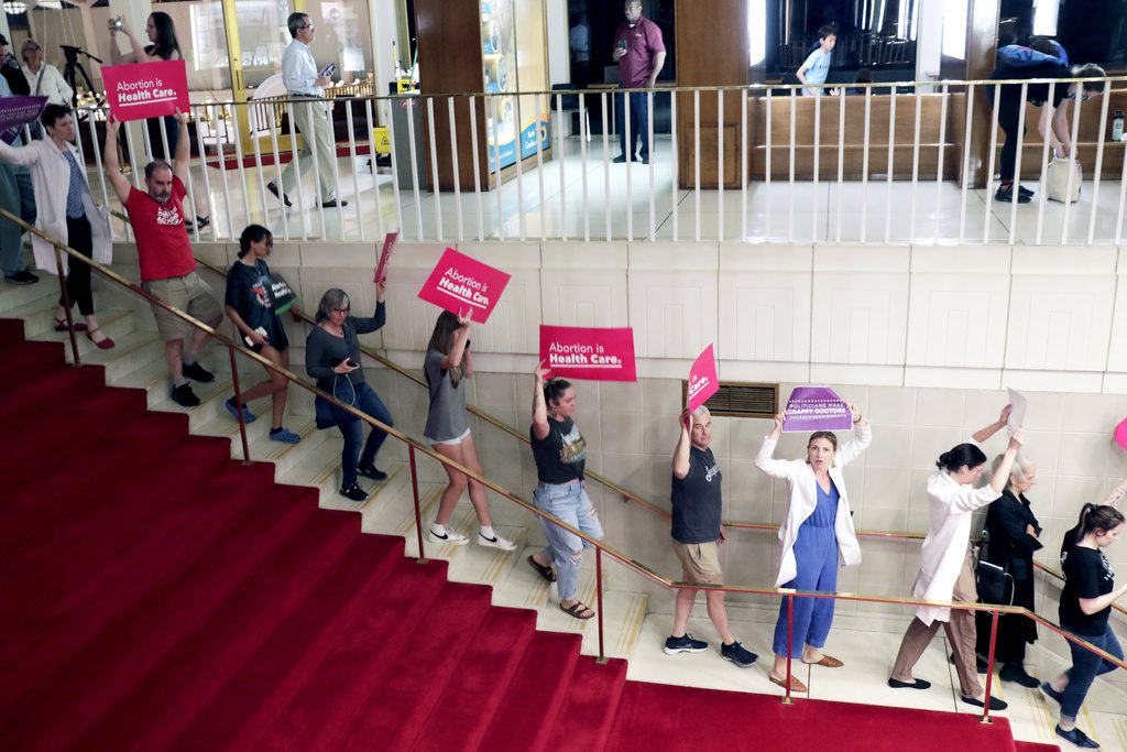 Photo of pro-abortion protesters walking down stairs of the NC General Assembly.